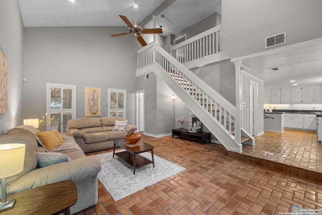 living room with high vaulted ceiling and ceiling fan