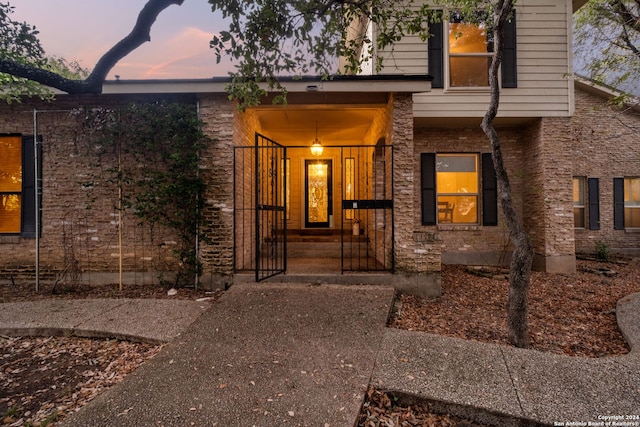 exterior entry at dusk featuring a porch