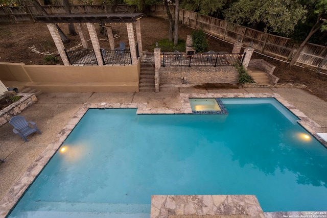 view of pool at twilight