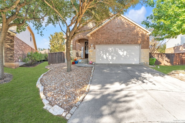 view of front of home with a garage and a front lawn