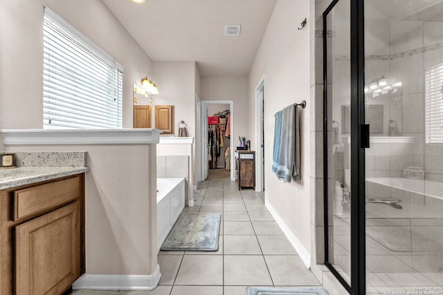 bathroom with vanity, tile patterned flooring, and separate shower and tub