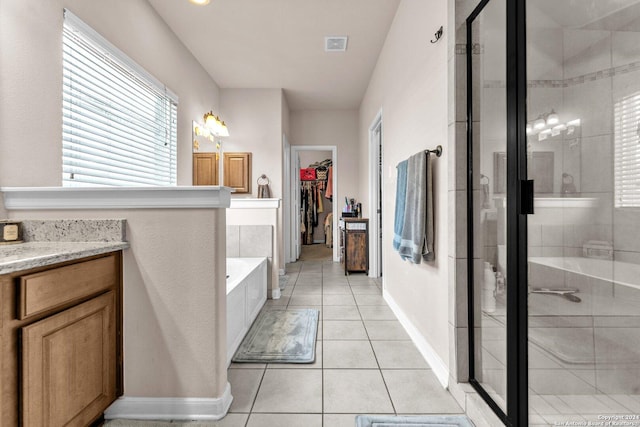 12639 Perini Rnch, San Antonio, TX 78254 - full bathroom with a shower stall, a garden tub, vanity, tile patterned floors, and a walk in closet