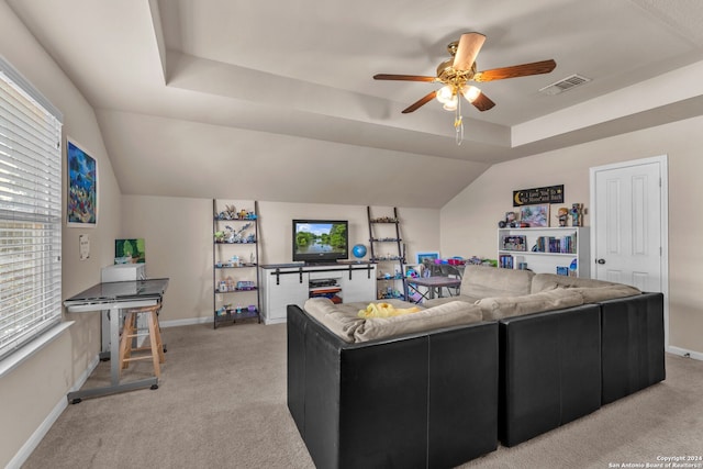 living room featuring vaulted ceiling, light carpet, and ceiling fan