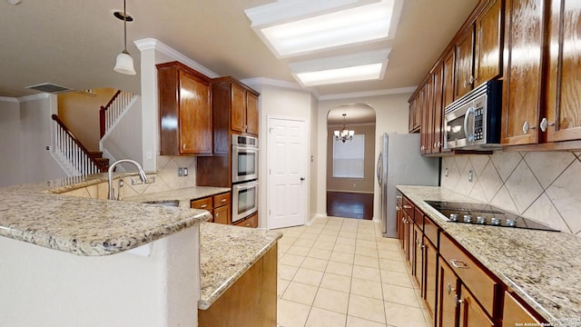 kitchen with sink, tasteful backsplash, crown molding, pendant lighting, and appliances with stainless steel finishes