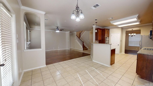 kitchen featuring refrigerator, oven, light tile patterned floors, and ornamental molding