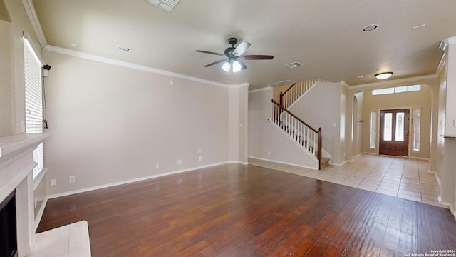 unfurnished living room featuring ceiling fan, light wood-type flooring, and crown molding