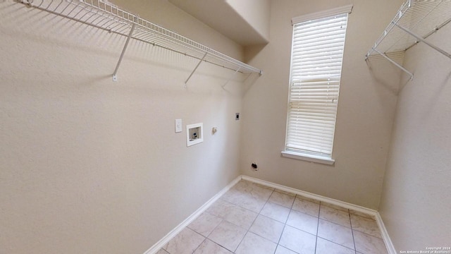 laundry room featuring electric dryer hookup, light tile patterned floors, hookup for a gas dryer, and washer hookup