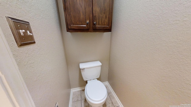 bathroom with tile patterned flooring and toilet