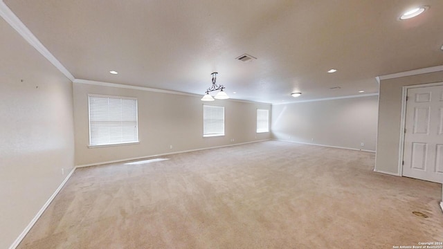 empty room featuring light carpet and crown molding