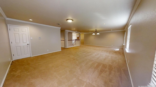 unfurnished living room with light colored carpet, ceiling fan, and crown molding