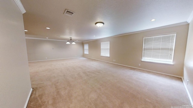 carpeted spare room featuring ornamental molding, a textured ceiling, and ceiling fan