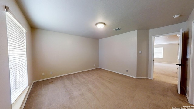 unfurnished room featuring light colored carpet