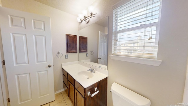 bathroom with vanity, tile patterned floors, and toilet