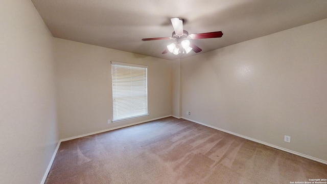 spare room with ceiling fan and light carpet