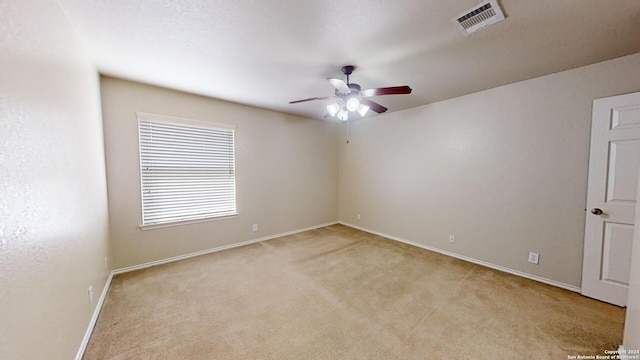 carpeted spare room with ceiling fan