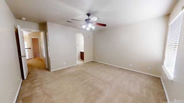 unfurnished bedroom with ceiling fan and light colored carpet