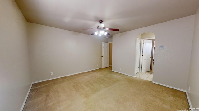 unfurnished room featuring light colored carpet and ceiling fan