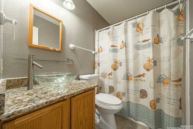 bathroom with vanity, tile patterned floors, a shower with shower curtain, toilet, and a textured ceiling