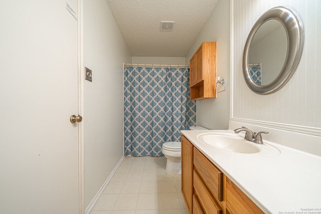 bathroom featuring vanity, toilet, and a textured ceiling