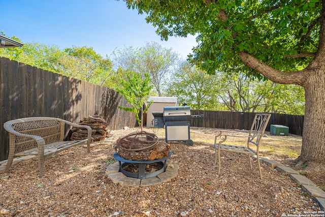 view of yard with an outdoor fire pit