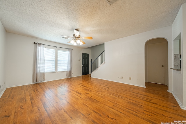 spare room with ceiling fan, a textured ceiling, and hardwood / wood-style flooring