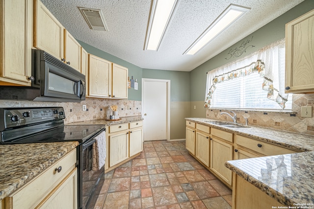 kitchen with light stone countertops, light brown cabinetry, sink, and black appliances