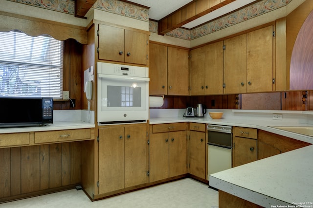 kitchen with beamed ceiling and white oven