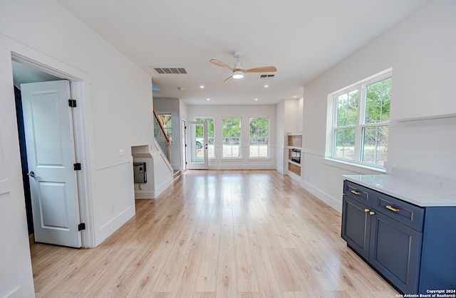 unfurnished living room with light hardwood / wood-style floors and ceiling fan