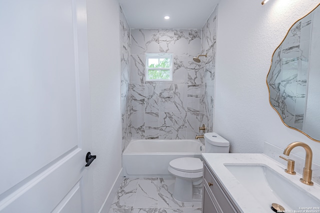 full bathroom with toilet, vanity, and tiled shower / bath