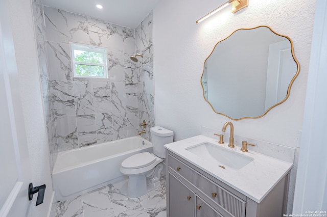 full bathroom featuring toilet, vanity, and tiled shower / bath