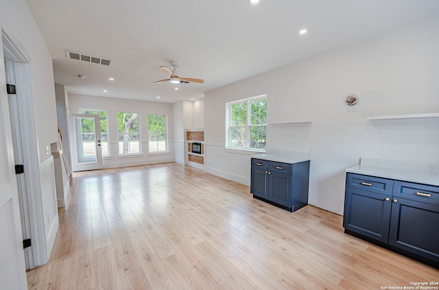 kitchen with ceiling fan, light hardwood / wood-style flooring, and blue cabinets