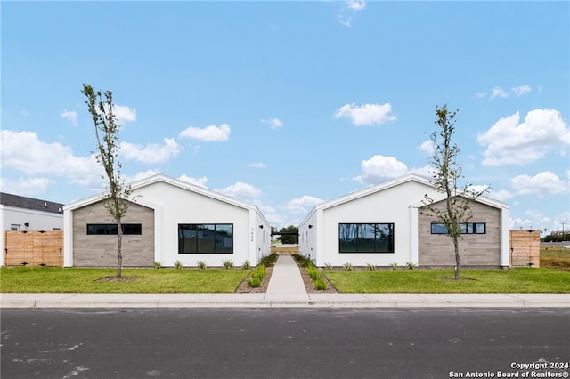 modern farmhouse with a front lawn