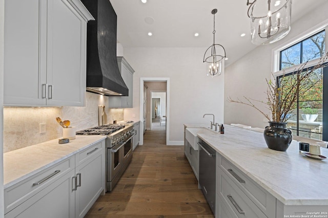 706 W Creek, Fredericksburg, TX 78624 - kitchen with premium range hood, dark hardwood / wood-style floors, light stone countertops, decorative light fixtures, and stainless steel appliances