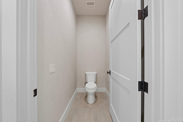 706 W Creek, Fredericksburg, TX 78624 - bathroom featuring hardwood / wood-style flooring and toilet