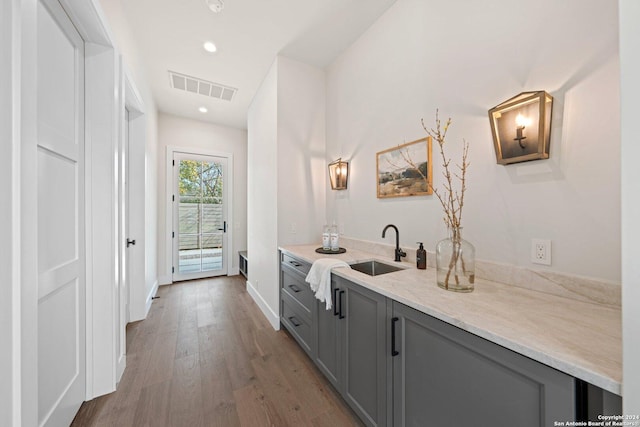 706 W Creek, Fredericksburg, TX 78624 - bar with wood-type flooring, gray cabinetry, and sink