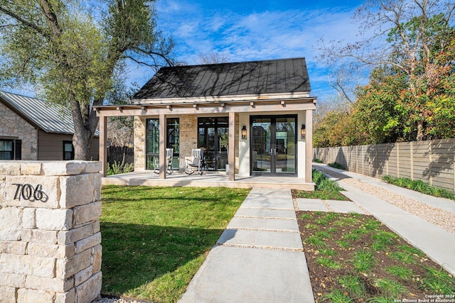 706 W Creek, Fredericksburg, TX 78624 - back of property featuring a lawn and french doors