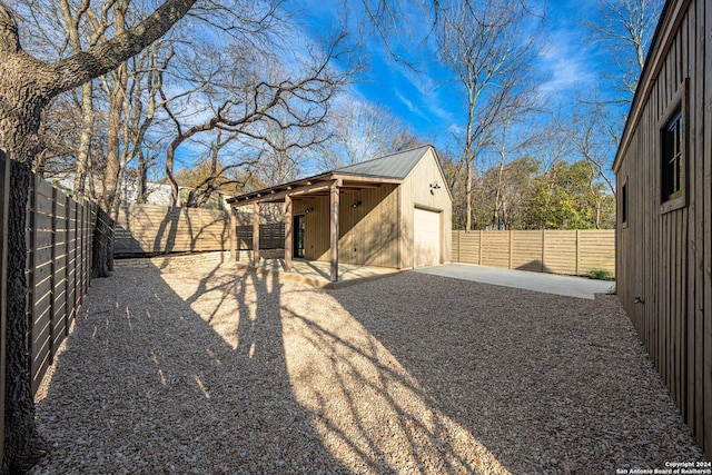 706 W Creek, Fredericksburg, TX 78624 - view of yard with an outbuilding, a patio, and a garage