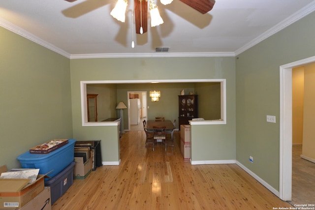 unfurnished room featuring light hardwood / wood-style floors, ceiling fan, and ornamental molding