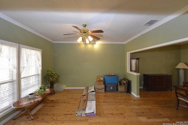 interior space featuring hardwood / wood-style flooring, crown molding, and ceiling fan