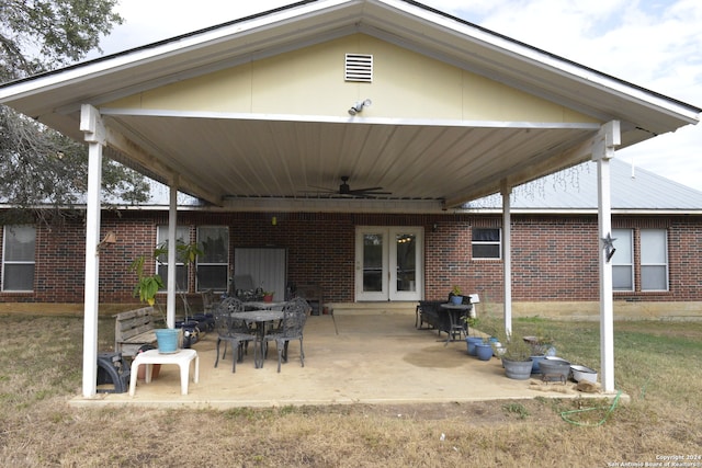 rear view of house with ceiling fan, a yard, and a patio area