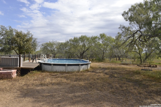 view of yard with a pool side deck