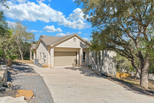 view of front of home with cooling unit and a garage