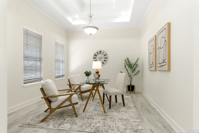 dining space with a raised ceiling, light hardwood / wood-style flooring, and ornamental molding