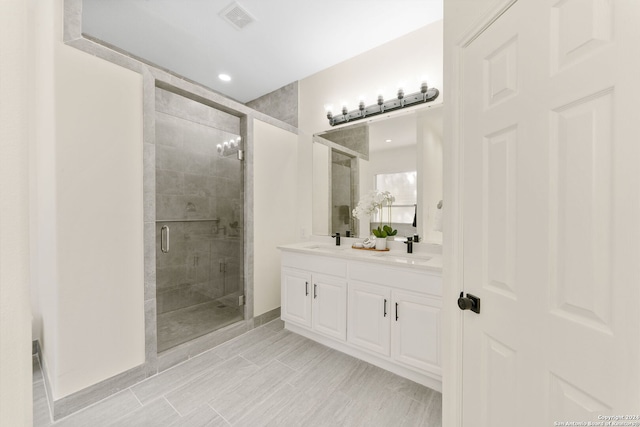 bathroom featuring vanity and a shower with door