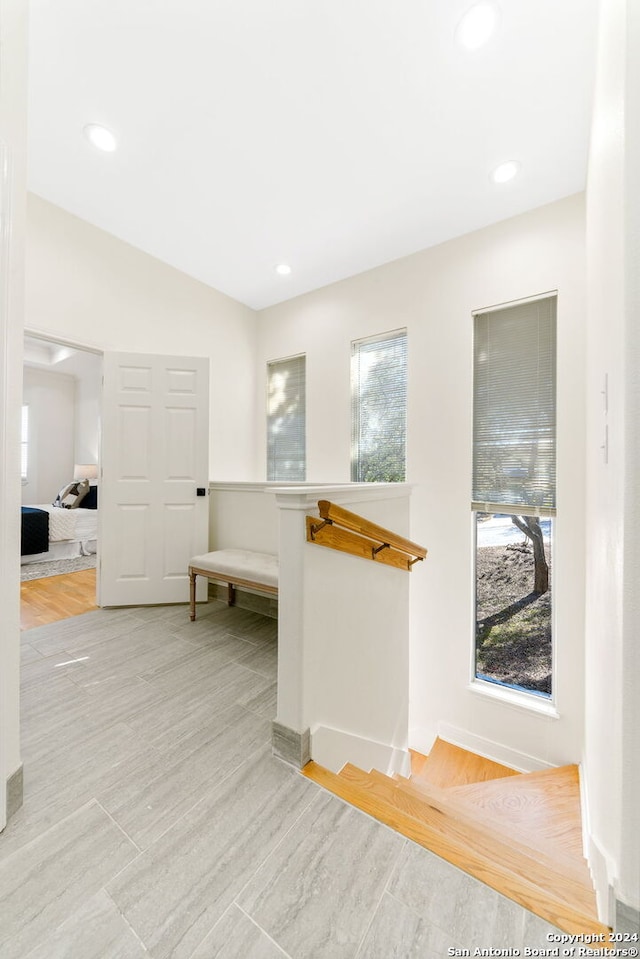 hallway with light hardwood / wood-style floors