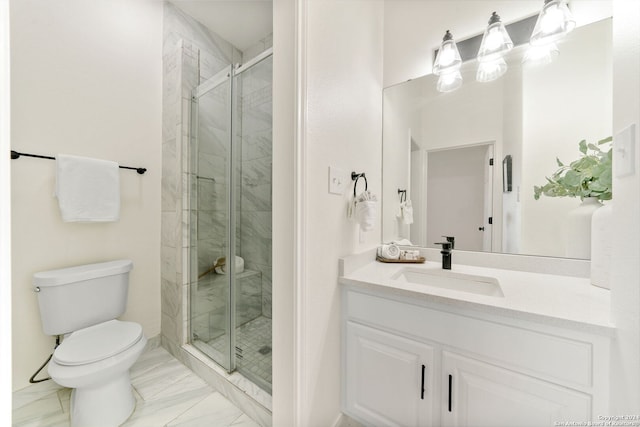 bathroom featuring vanity, an enclosed shower, and toilet