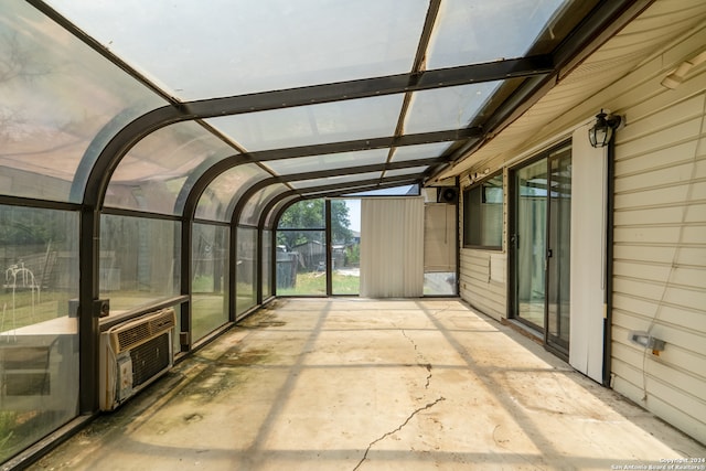 unfurnished sunroom with lofted ceiling