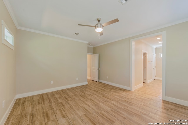 spare room featuring light wood-type flooring, ceiling fan, and ornamental molding