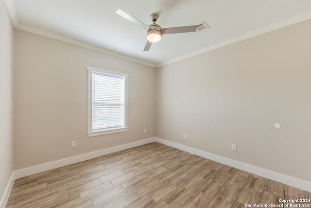 empty room with ornamental molding, light wood-type flooring, and ceiling fan