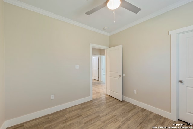 spare room featuring light hardwood / wood-style floors, ceiling fan, and crown molding